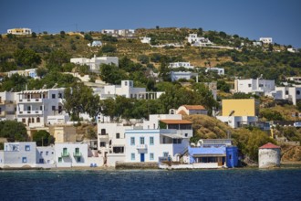 White-blue houses along the coast in front of a green hill, Lakki, Leros, Dodecanese, Greek
