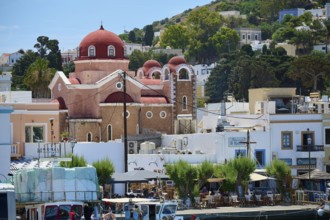 Church with red domes in a lively harbour town surrounded by boats, Lakki, Leros, Dodecanese, Greek