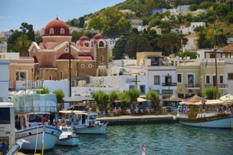 Picturesque coastal town with church, many boats and characteristic Mediterranean buildings, Lakki,