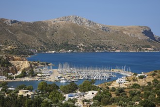 Panoramic view of a harbour full of sailing ships on a picturesque coastal landscape, Lakki, Leros,
