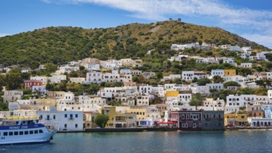 Colourful houses on a green hill, right by the sea, radiant atmosphere, Lakki, Leros, Dodecanese,