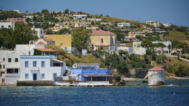 Coastline with mill and typical Greek houses on the blue water, Lakki, Leros, Dodecanese, Greek