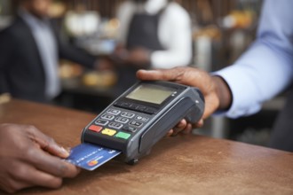 Businessman using payment terminal, credit card is inserted in POS to complete digital payment, AI