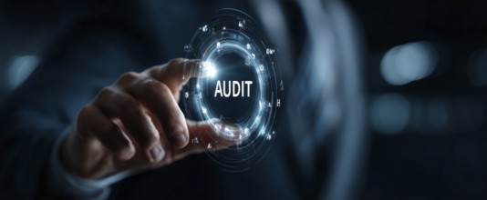 Businessman touching a digital, glowing, futuristic, modern hologram with the text Audit and