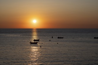 Boats in front of sunset at the sea, North Sea, English Channel, Étretat, evening mood,