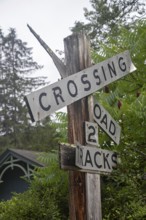 Clover Lick, West Virginia - An old railroad crossing sign stands next to the Greenbrier River