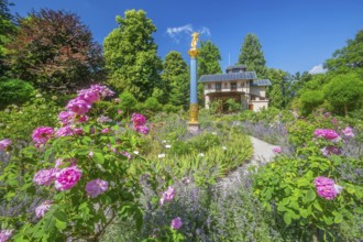 Rosarium with blooming roses in front of the Pompeian-Bavarian Casino on the Rose Island in Lake