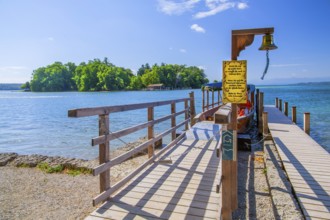 Bell jetty on the lakeshore with a view of Roseninsel in Lake Starnberg, Feldafing, Upper Bavaria,