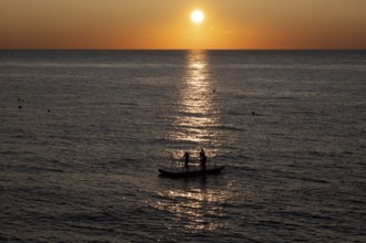 Children playing on bathing island, bathing raft, swimming island, Étretat, sea, sunset, evening