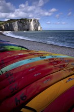 Kayaks, boats, colourful, lying on the beach, pebble beach, rock arch Falaise or Porte d'Aval,