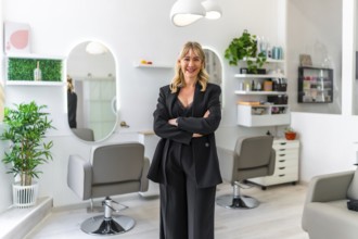 Portrait of a successful female business owner posing proudly in her modern hair and beauty salon,