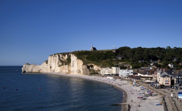 Rock arch Falaise or Porte d'Amont, beach, behind it monument in honour of the French aviators