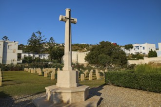 Large cross on a cemetery with surrounding buildings and trees, Military cemetery, Commonwealth War