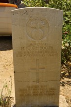 Gravestone of a soldier with cross and inscription in warm light, Hugh Gore-Booth, Irishman,