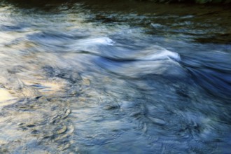 Waves in the river, river landscape, evening sun, motion blur, light reflections, Iceland