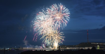 Bright illuminated colours, atmospheric fireworks in red, green and gold, Heligoland island
