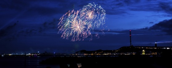Radiant luminous colours, atmospheric fireworks in red, green and gold, Heligoland island festival,