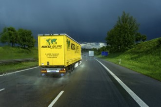 Overtaking manoeuvre of articulated lorry, lorry overtaking in thunderstorm, heavy rain, poor