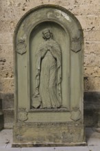 Old gravestone in front of St Martin's Church, catholic church, graceful female figure, relief,