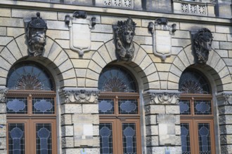 Police building, architectural detail, stained glass, arched window, sun motif, from left to right: