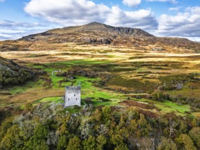 Autumn colours over Castell Dolwyddelan and Eryri Mountains from a drone, Snowdonia, Conwy County