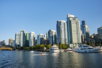 Sailing boats in marina, skyscrapers on the promenade, Coal Harbour, Vancouver, British Columbia,