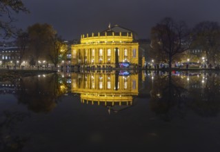 The Stuttgart Opera House is reflected in Eckensee in the evening. Stuttgart, Baden-Württemberg,