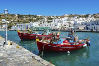 Mykonos, Cyclades, Greece - Colourful fishing boats are moored on the quay in the old port of