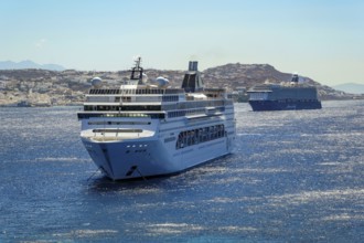 Mykonos, Cyclades, Greece - Cruise ships MEIN SCHIFF 5 and MSC LIRICA are located in the bay off