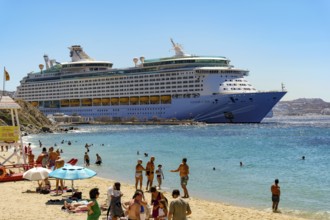 Mykonos, Cyclades, Greece - Voyager of the Seas cruise ship is located in Mykonos Harbour Bay. In