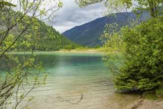 Landscape of Lake Offensee after rain when the sun comes through the clouds in spring,