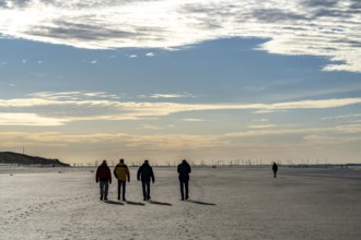 Walkers on the Wadden Sea near the East Frisian island of Spiekeroog, west of the North Sea island,