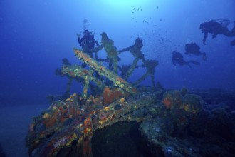 Divers explore a paddle wheel covered with sea sponges in the Mediterranean near Hyères, Wreck
