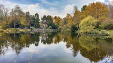 View in autumn across pond at Ehrenmal Pond in the Wittringer Wald recreation area, Gladbeck, North