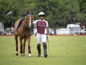 Polo player Nicolas Pieres from Team Zeta Kazak with his injured horse, the bleeding wound visible