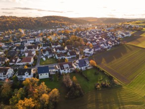 Settlement and fields in evening light, autumn hills with colorful trees, Aidlingen, Böblingen
