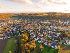 Pretty village surrounded by colorful autumn trees at sunset, Aidlingen, Böblingen district,