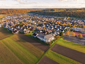 Large-scale view of a village bordering fields, in warm autumn light, Aidlingen, Böblingen