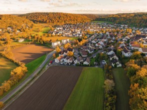 Autumn scenery of a village near fields and forests at sunset, Aidlingen, Böblingen district,