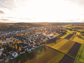Wide view of a village surrounded by fields at sunset, Aidlingen, Böblingen district, Germany