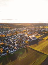 A village in warm autumn light with surrounding fields, Aidlingen, Böblingen district, Germany