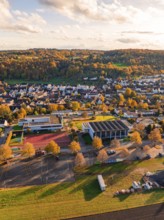 Landscape with village and school surrounded by autumn trees, Aidlingen, Böblingen district,