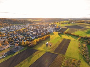 Diverse fields and settlement under autumn evening light in hilly area, Aidlingen, Böblingen