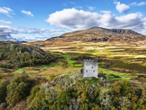 Autumn colours over Castell Dolwyddelan and Eryri Mountains from a drone, Snowdonia, Conwy County