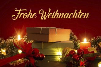 Christmas greetings: table with Christmas decoration and gifts against a red background with