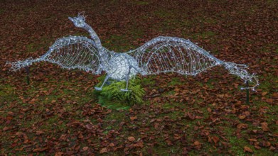 Swan made of wire and fairy lights, on leafy meadow, Historisches Hotel La Villa, Niederpöcking,