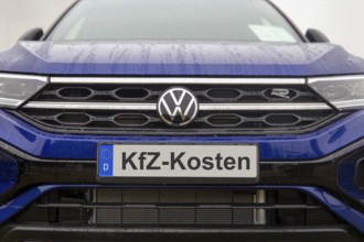 (photo montage) Close-up of a license plate with text Car costs