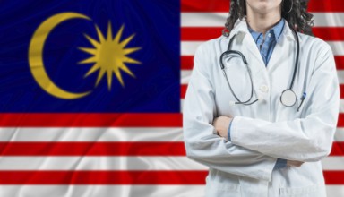 Medical professional on Malaysia flag. Healthcare and wellness in Malaysia, Concept