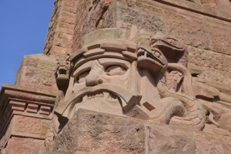 Warrior's face with snake figure and dragon at the Kyffhäuser monument, detail, figure, stone, red,
