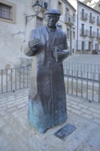 Sculpture and monument to priest Don Ramon Nunez Martin, statue man with book, life-size, bronze